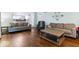 Spacious living room with dark hardwood floors and gray furniture, perfect for relaxing and entertaining at 12961 Limberlost Dr, Carmel, IN 46033