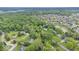 Expansive aerial view of a lush residential neighborhood with mature trees and a nearby lake at 13297 Highland Springs Dr, McCordsville, IN 46055