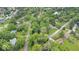 Aerial view of homes in a neighborhood with mature tree coverage and a pond at 13297 Highland Springs Dr, McCordsville, IN 46055