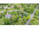 An aerial view shows a neighborhood with mature trees and well-maintained lawns at 13297 Highland Springs Dr, McCordsville, IN 46055
