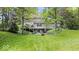 Back exterior view showcasing deck, patio, and landscaped yard at 13297 Highland Springs Dr, McCordsville, IN 46055