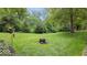 Expansive backyard featuring a fire pit and lush landscaping at 13297 Highland Springs Dr, McCordsville, IN 46055