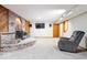Finished basement with wood-burning stove on a brick hearth and a flat screen television at 13297 Highland Springs Dr, McCordsville, IN 46055