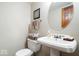 Cozy powder room featuring a pedestal sink, oval mirror, and decorative towels at 13297 Highland Springs Dr, McCordsville, IN 46055
