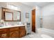 Classic bathroom with a vanity, storage cabinet and a shower-tub combo featuring neutral tiling at 13297 Highland Springs Dr, McCordsville, IN 46055