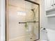 Elegant bathroom with a glass-enclosed shower, beige tiled walls, and modern fixtures at 13297 Highland Springs Dr, McCordsville, IN 46055