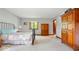Sunlit bedroom with plush carpet, wrought iron bed frame, and wooden dresser providing ample storage at 13297 Highland Springs Dr, McCordsville, IN 46055