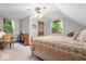 Comfortable bedroom with natural light, featuring wood furnishings, pitched ceiling, and neutral walls at 13297 Highland Springs Dr, McCordsville, IN 46055