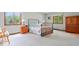Spacious bedroom featuring a wrought iron bed frame and large windows overlooking the outside greenery at 13297 Highland Springs Dr, McCordsville, IN 46055