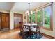 Bright breakfast nook with wooden table set and a large window view of the lush greenery outdoors at 13297 Highland Springs Dr, McCordsville, IN 46055