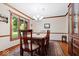 Dining room featuring hardwood floors, wood trim, a chandelier, and six chairs at 13297 Highland Springs Dr, McCordsville, IN 46055