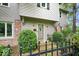 Close-up of the front door, sidelights, house number, and a charming black fence with greenery at 13297 Highland Springs Dr, McCordsville, IN 46055