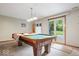 Basement game room featuring a pool table with a walkout to the backyard at 13297 Highland Springs Dr, McCordsville, IN 46055