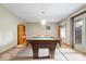 Basement game room with a pool table, light fixture and door to the outside at 13297 Highland Springs Dr, McCordsville, IN 46055