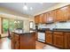 Kitchen showcasing wooden cabinets, granite countertops, and a central island at 13297 Highland Springs Dr, McCordsville, IN 46055