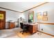 Well-lit office with a large window, wood trim, and a functional workspace at 13297 Highland Springs Dr, McCordsville, IN 46055