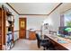 Cozy office with built-in bookshelves, wood trim, and a large desk area for productivity at 13297 Highland Springs Dr, McCordsville, IN 46055