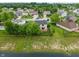 Back of home with a well-maintained lawn, landscaping, and a view of the neighborhood pond at 1408 Snead Cir, Avon, IN 46123