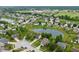 Aerial view of a residential neighborhood featuring a pond and an adjacent school at 1408 Snead Cir, Avon, IN 46123