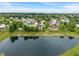 Panoramic aerial view of a neighborhood surrounding a pond, with many trees and manicured lawns at 1408 Snead Cir, Avon, IN 46123