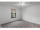 Comfortable carpeted bedroom with natural light from the window, complemented by a ceiling fan at 1408 Snead Cir, Avon, IN 46123