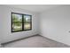 A sunlit bedroom, carpeted, with a large window offering a view of the neighborhood at 1408 Snead Cir, Avon, IN 46123