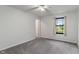 Bright bedroom with a ceiling fan, a large window view and neutral carpeting for a cozy and inviting space at 1408 Snead Cir, Avon, IN 46123