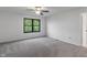 Carpeted bedroom with view through window, ceiling fan and a white ceiling at 1408 Snead Cir, Avon, IN 46123