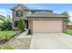 Charming two-story home features a brick and vinyl facade, a two-car garage, and a neatly maintained front lawn at 1408 Snead Cir, Avon, IN 46123