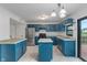 Well-lit kitchen with stylish blue cabinets, a stainless steel refrigerator, and a tiled island countertop at 1408 Snead Cir, Avon, IN 46123