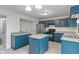 Well lit kitchen with stainless steel refrigerator and dark blue cabinets at 1408 Snead Cir, Avon, IN 46123