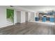 Open-concept living area with hardwood floors, flowing into a kitchen with blue cabinets and stainless steel appliances at 1408 Snead Cir, Avon, IN 46123