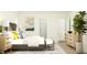 Bright bedroom showcasing a stylish bed with decorative pillows, bedside tables, and modern art at 15363 Alperton Rd, Fishers, IN 46037