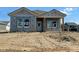 New construction home featuring a covered porch and bright windows, awaiting landscaping to complete its charming facade at 15363 Alperton Rd, Fishers, IN 46037