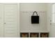 Functional mudroom with built-in bench, hooks, and storage baskets at 15363 Alperton Rd, Fishers, IN 46037
