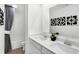 Bathroom features double sinks, quartz countertops, and modern black and white artwork at 15387 Alperton Rd, Fishers, IN 46037