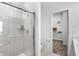 Modern bathroom featuring a glass-enclosed shower and an open view into the walk-in closet at 15387 Alperton Rd, Fishers, IN 46037