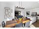 Modern dining room showcasing a wooden table, contemporary chairs, and open access to the living area at 15387 Alperton Rd, Fishers, IN 46037