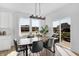 Open dining space featuring a wooden table, contemporary chairs, and sliding glass doors with backyard view at 15387 Alperton Rd, Fishers, IN 46037