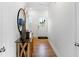 Bright entryway with hardwood floors, decorative mirror, stylish console table and view of front door at 15387 Alperton Rd, Fishers, IN 46037