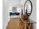 Bright entryway with a decorative mirror, stylish console table, and view of living room at 15387 Alperton Rd, Fishers, IN 46037
