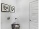 Bright laundry area featuring modern fixtures, artistic wall decor, and a stylish laundry basket at 15387 Alperton Rd, Fishers, IN 46037