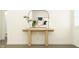 Minimalist foyer featuring a light wood console table, mirror, and stylish decor at 15395 Alperton Rd, Fishers, IN 46037