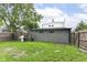 Spacious backyard with a well-maintained lawn, BBQ grill, privacy fence, and metal building at 1620 W New York St, Indianapolis, IN 46222