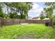 Spacious fenced backyard featuring lush greenery, perfect for outdoor activities and entertaining with a grill ready for a barbecue at 1620 W New York St, Indianapolis, IN 46222