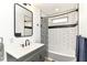 Stylish bathroom with modern fixtures, subway tile, and a shower-tub combo, creating a clean design at 1620 W New York St, Indianapolis, IN 46222