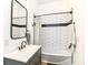 Stylish bathroom featuring subway tile with black trim, modern fixtures and a grey vanity at 1620 W New York St, Indianapolis, IN 46222