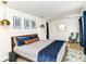 A bedroom with stylish decor, elegant pendant lighting, and a comfortable seating area by the window at 1620 W New York St, Indianapolis, IN 46222