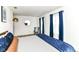 Bright bedroom with stylish decor, wood floors, and natural light from the window with blue curtains at 1620 W New York St, Indianapolis, IN 46222