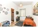 Cozy bedroom with eclectic décor, a decorative window treatment, and a view to the attached bathroom at 1620 W New York St, Indianapolis, IN 46222